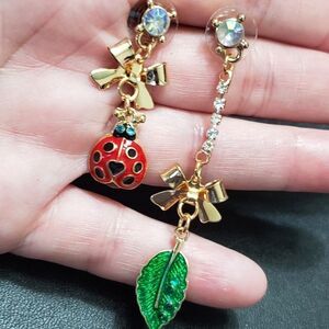 Gold tone ladybug leaf asymmetrical earrings